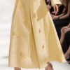 Elegant yellow midi skirt with a flared design and vertical pleats.