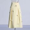 Elegant yellow midi skirt with a flared design and vertical pleats.